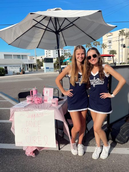 Annelise Henwood (left) and Allie Ward (right) manage the spirit night stand at Long Doggers Satellite Beach on behalf of the Purrfections Dance Team on Oct. 15.