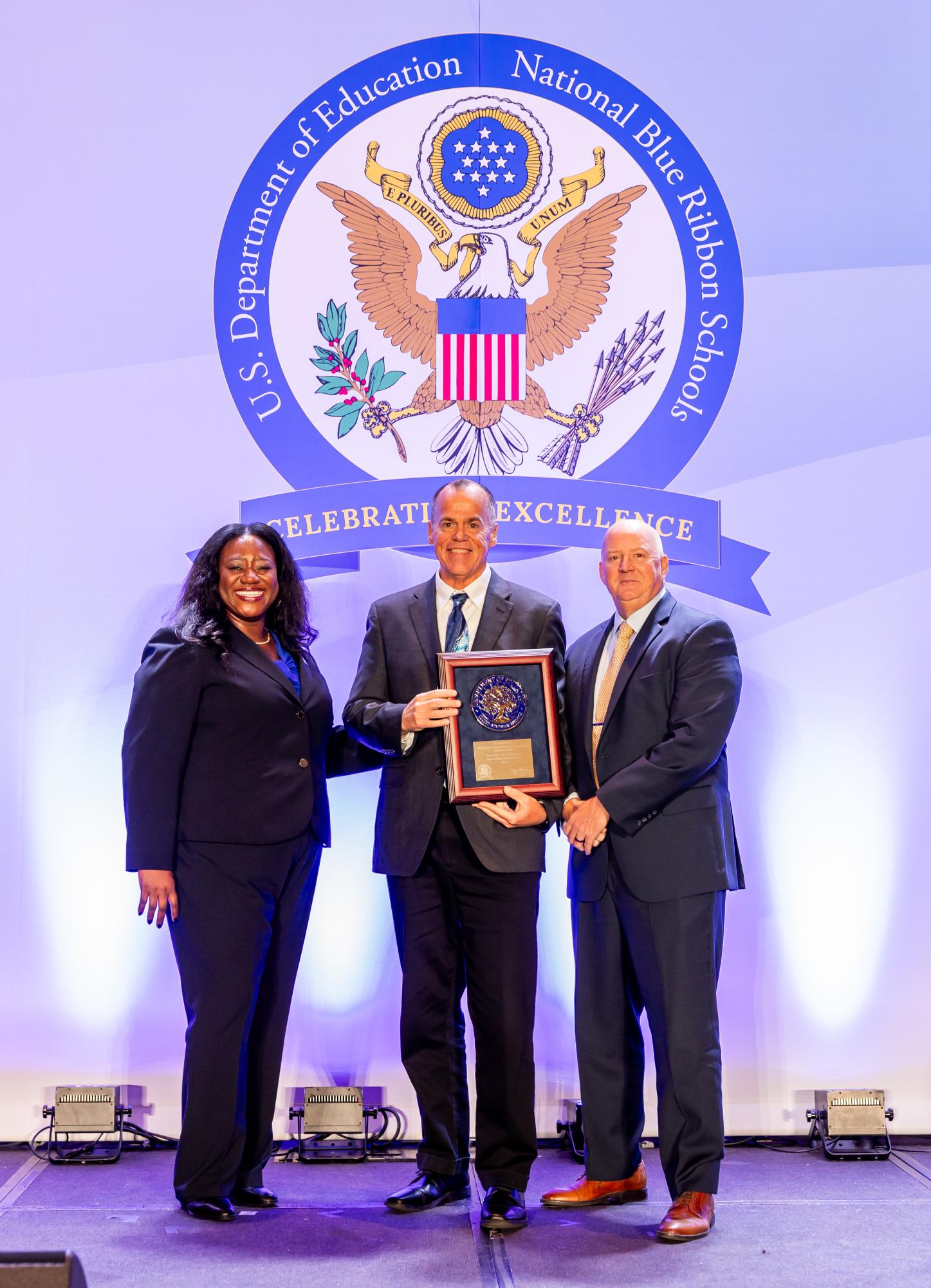 “2024BlueRibbon_Day2_Recipients-179” / US Department of Education / https://www.flickr.com/photos/
departmentofed/54128326198/in/album-72177720321816706 / CC BY 2.0

Assistant Principal Glenn Webb (middle) and BPS
Superintendent Mark Rendell (right) pose with National Blue Ribbon Schools Program Director Aba Kumi (left) at the award ceremony held in Washington D.C. on Nov. 8.