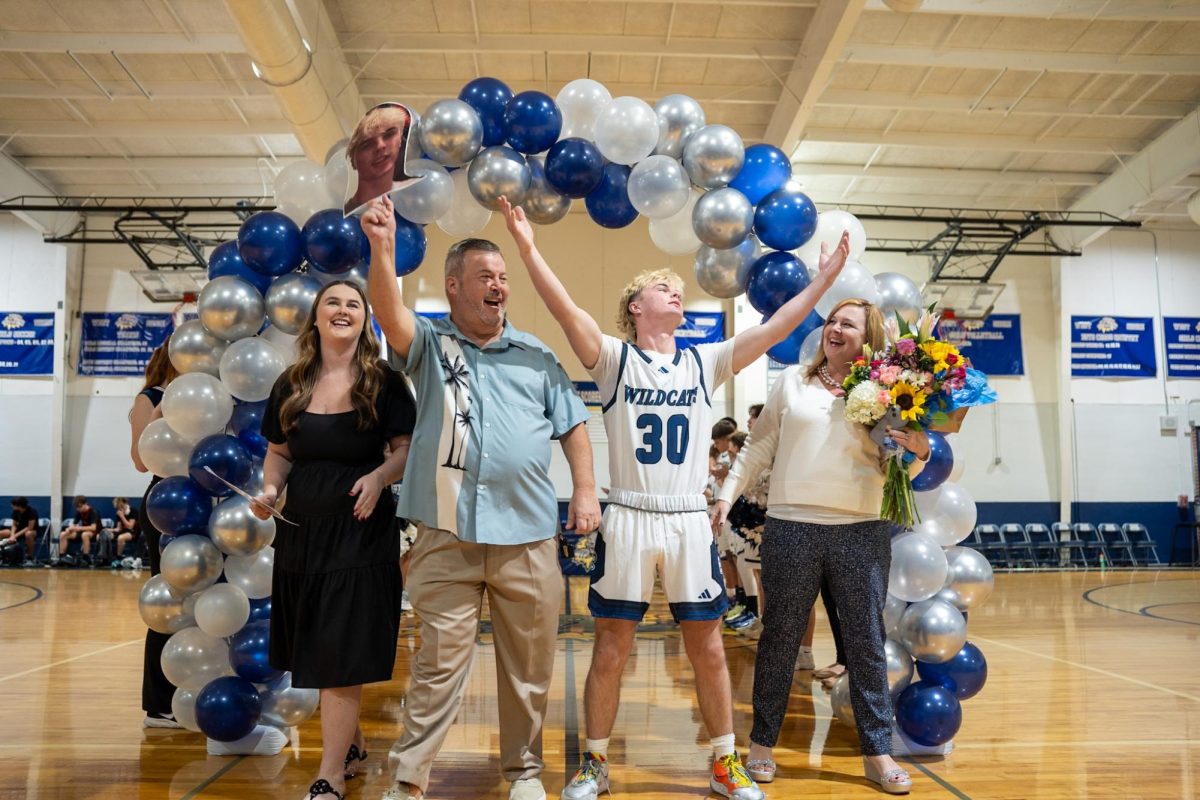 Senior Trey Hatter celebrates as he walks down the court alongside his family during boys basketball Senior Night on Jan. 31. "I had to practice leading up to this to put forth my best effort on the court," Hatter said. "After the game a lot of people recognized I had Michael Jordan like talent."