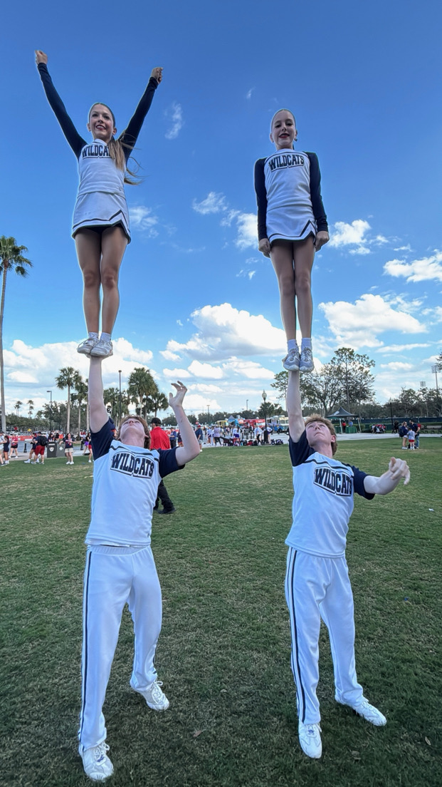 Sophomore Chase Kingery (bottom right) practices stunting for the nationals competition.