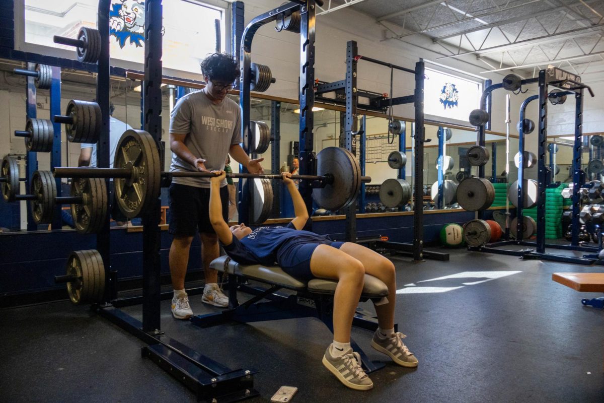 Senior Chloe Marrs prepares to bench press during her West Shore weightlifting class on Tuesday, Feb. 4. “I like weightlifting because it pushes me to be the best I can,” Marrs said.