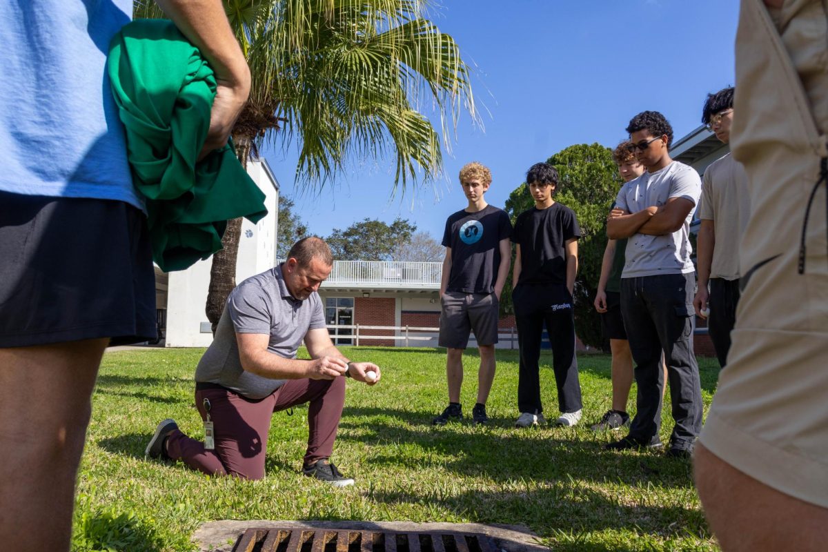 Physics teacher Joseph Estevez uses eggs to demonstrate the relationship between momentum and time for the AP Physics 1 class on Feb. 6. "It's a fun way to explain new concepts to the kids," Estevez said.