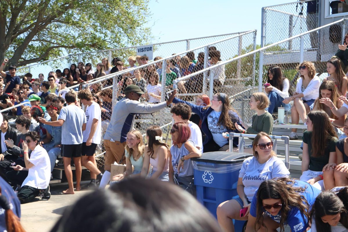 Students cheer for the performers in the air guitar competition.