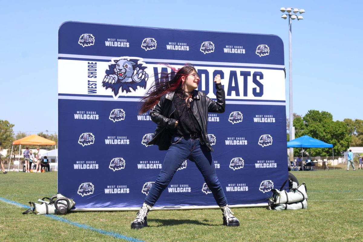 Junior Aradia DeRivi strums an air guitar during a contest. "I never got thought we would actually have an air guitar competition because it just seems so fictitious at West Shore,” DeRivi said. “Since we’re having one, I get to have fun, dress up a little, and have a Grease moment with the leather jacket. And I’ve never been so happy to have long hair.”
