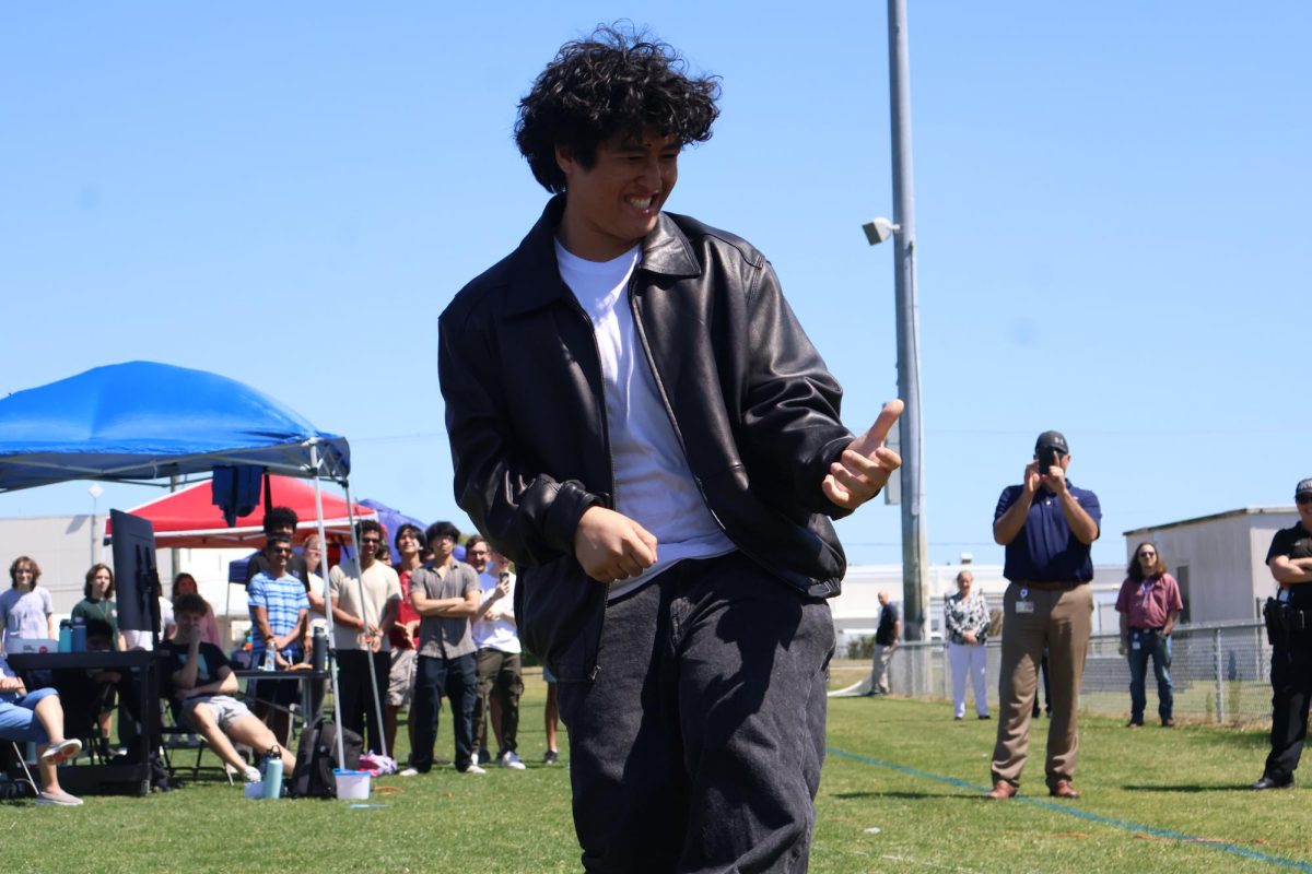 Senior Laith Zavala strums an imaginary guitar during a competition. “Me, the lads, the gentlemen, and the gentlewomen had amazing performances,” Zavala said. “For the first time, I like an event here and I hope they make it a tradition to inspire young cats to get wild and rock’n’roll.”
