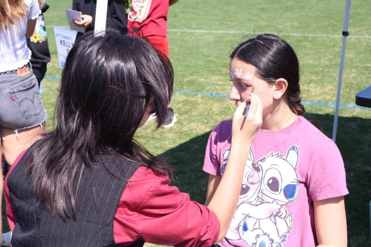 For the theater department, freshman Cathryn Cooper does face paint on freshman Lauralai Gant. “I got flowers painted on my face by Mike, who’s a tech kid for theater,” freshman Tiffany Duong said. “He was actually very professional. The experience was definitely worth the 50 cents I paid for it.”