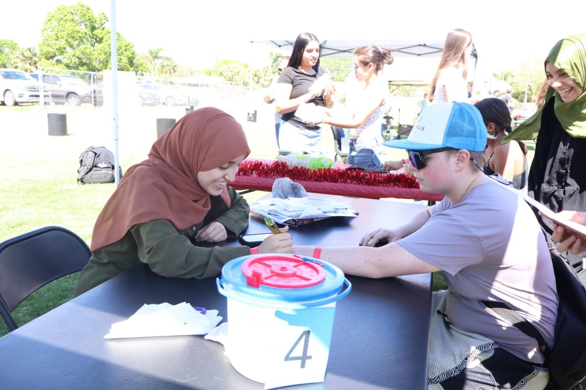 Junior Hlla Waregh does henna for the Multicultural Club. “We’re mainly trying to spread awareness over our club and show what our diverse cultures have to offer,” sophomore Raaha Sellamuthu said. “I feel like most people don’t even know most of these clubs exist. This whole event is a great way for clubs to advertise.”
