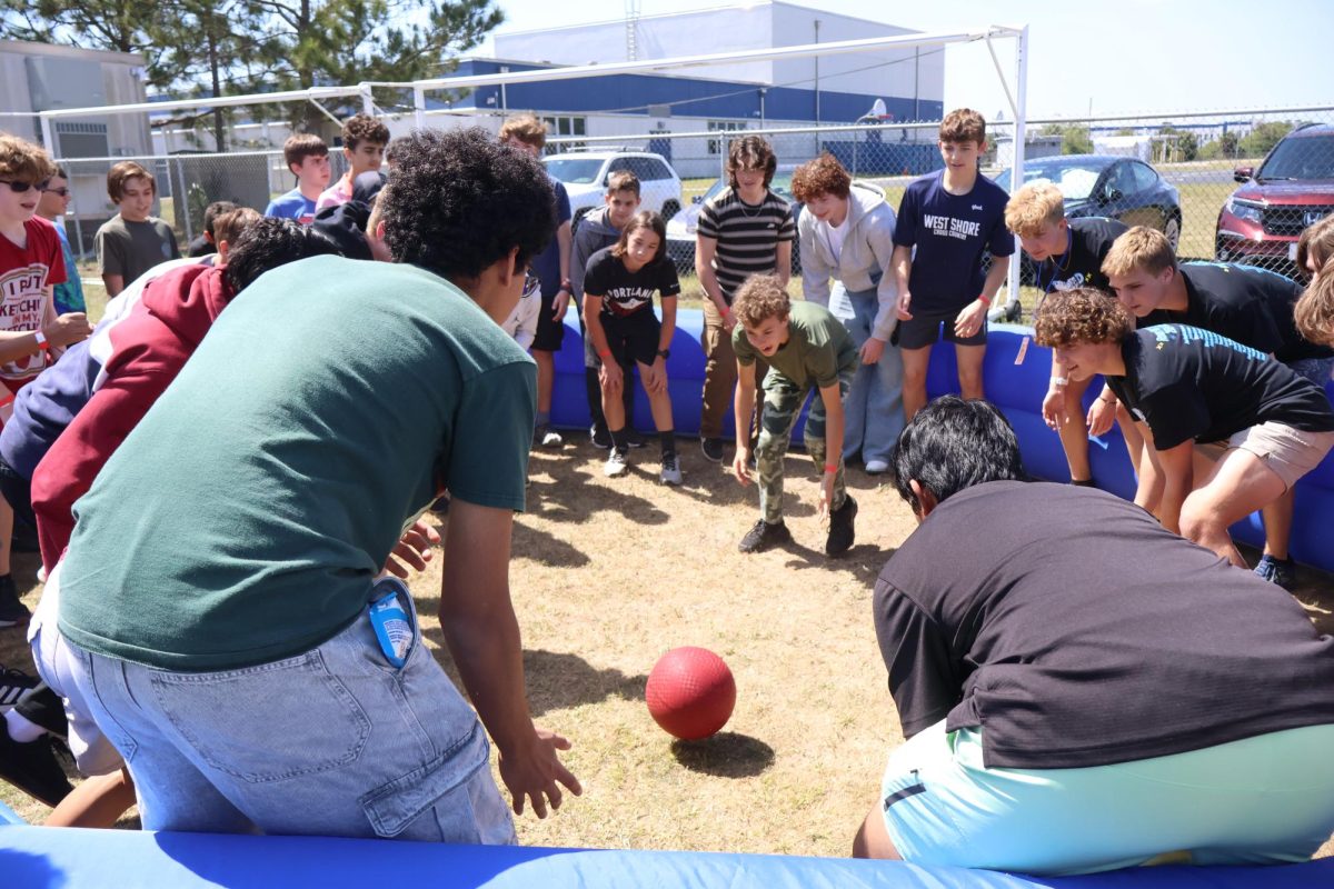 Students play Gaga ball, where players try to eliminate opponents by hitting them with a ball below the knees. “I’ve been playing Gaga ball for years now, as a boy scout,” junior Parker Wales said. “Although I think my lack of skill seen today comes from the mass amount of people in the pit. I’m typically used to bouncing the balls off the walls and on to people to get them out. The school should invest in an in-ground wooden gaga pit, then I’ll play better.”