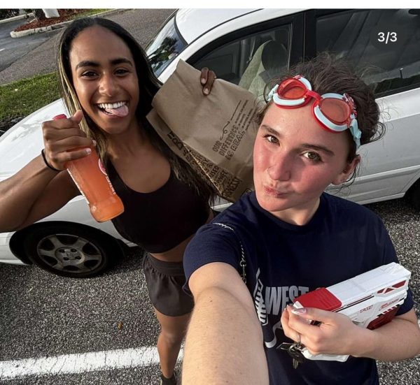 Senior Reese Armstrong (right) eliminates senior Lea Bygrave from the Senior Assassin competition on April 7.