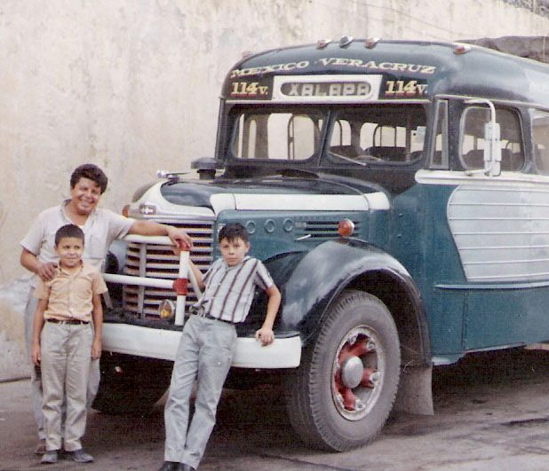 In the 1960s, Alberto Vasquez and his siblings pose in front of an old Mexican transport bus.