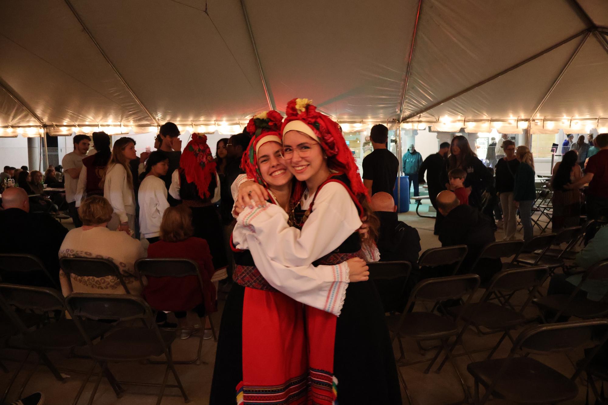 After dancing various Grecian styles at GreekFest on Feb. 22, senior Gianna (left) and sophomore Artemis Theodoropoulos hug in celebration.