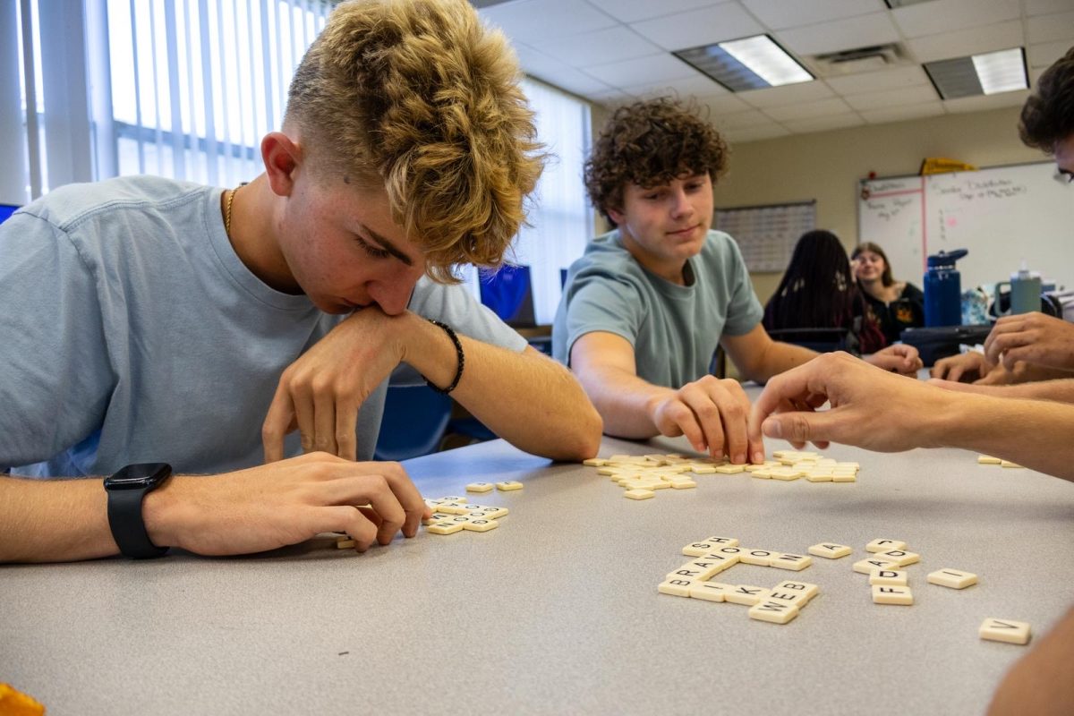 Juniors Jayden Collins and Michael Carroll play Bananagrams at Board Game Club during Power Hour in journalism teacher Linda Foster’s classroom on April 21. “Board Game Club (BGC) is always something great to look forward to on Mondays and Wednesdays,” Carroll said. “We would like to have a selection of games to play but every meeting it just ends up being Bananagrams. Even after failing a test, It’s a great feeling to glance at your buddies and ask ‘BGC?’”