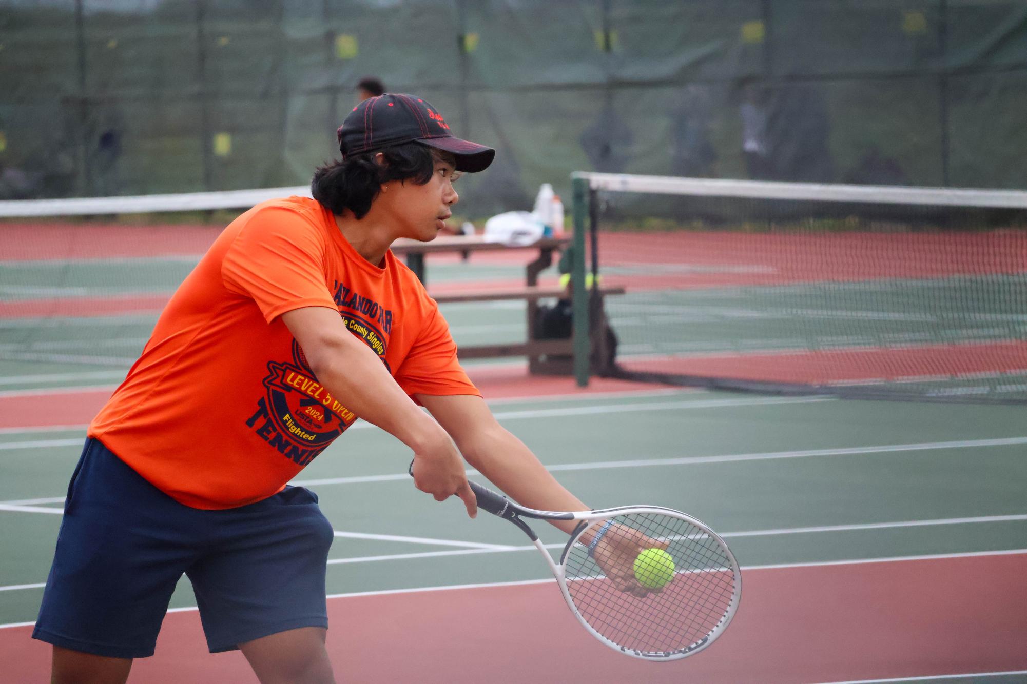 Junior Eric Yang prepares to serve in a match against Viera High School's Joey Shine on Feb. 18. Yang won the game 8-5.