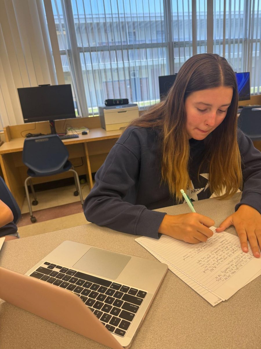 Sophomore Reagan Hill studies for her AP United States History exam. Hill reviews by looking over her old notes, then writing down what she remembers.