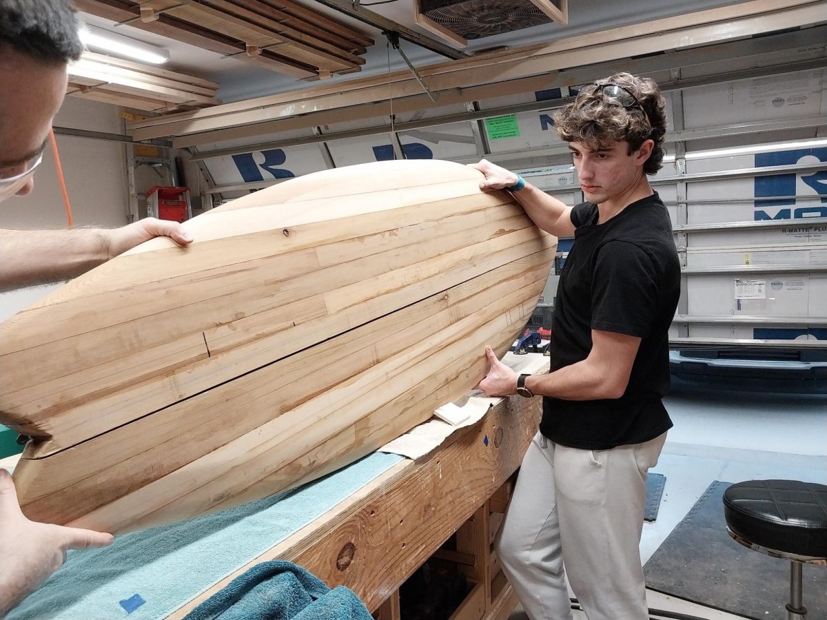 Senior Matthew Tucker handles his environmentally-friendly, wooden surfboard.