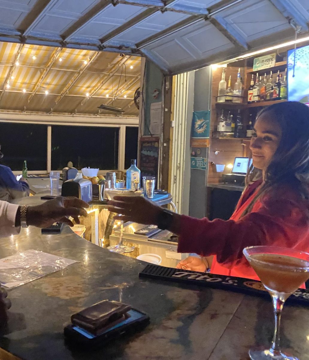 Senior Lea Bygrave serves a customer a drink at her workplace.