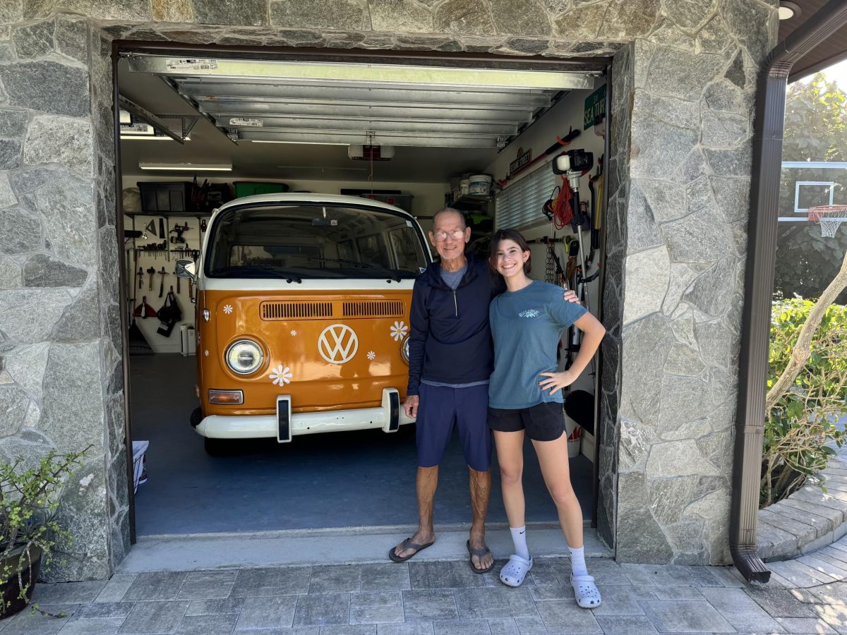 Senior Aubrey Reiter (right) and her mentor, Sak Chuntaruk, pose in front of her renovated 1971 Volkswagen minibus.