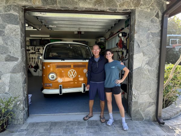 Senior Aubrey Reiter (right) and her mentor, Sak Chuntaruk, pose in front of her renovated 1971 Volkswagen minibus.