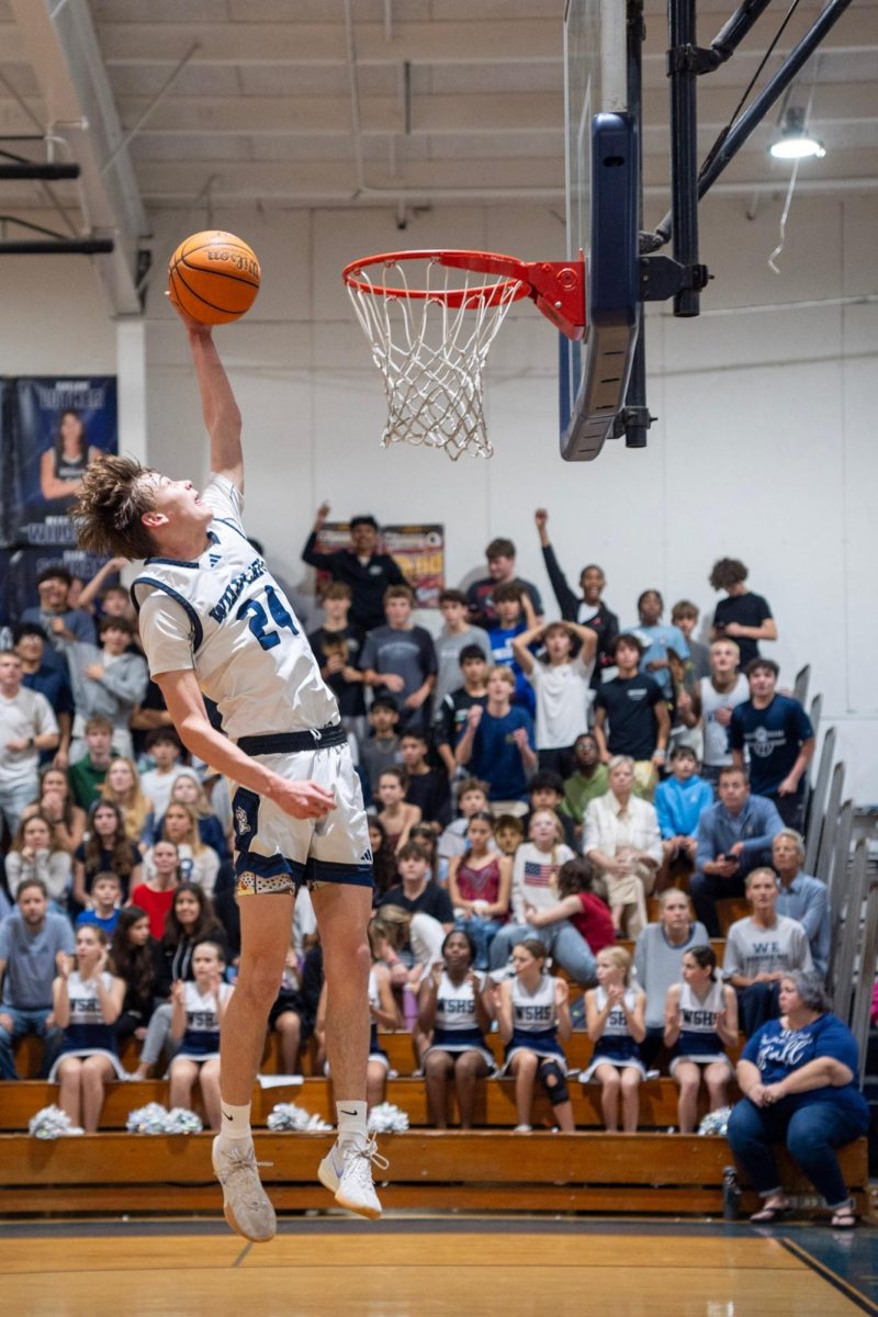 The student section watches as senior Christian Rebec attempts a dunk on Senior Night against Edgewood on Jan. 31.