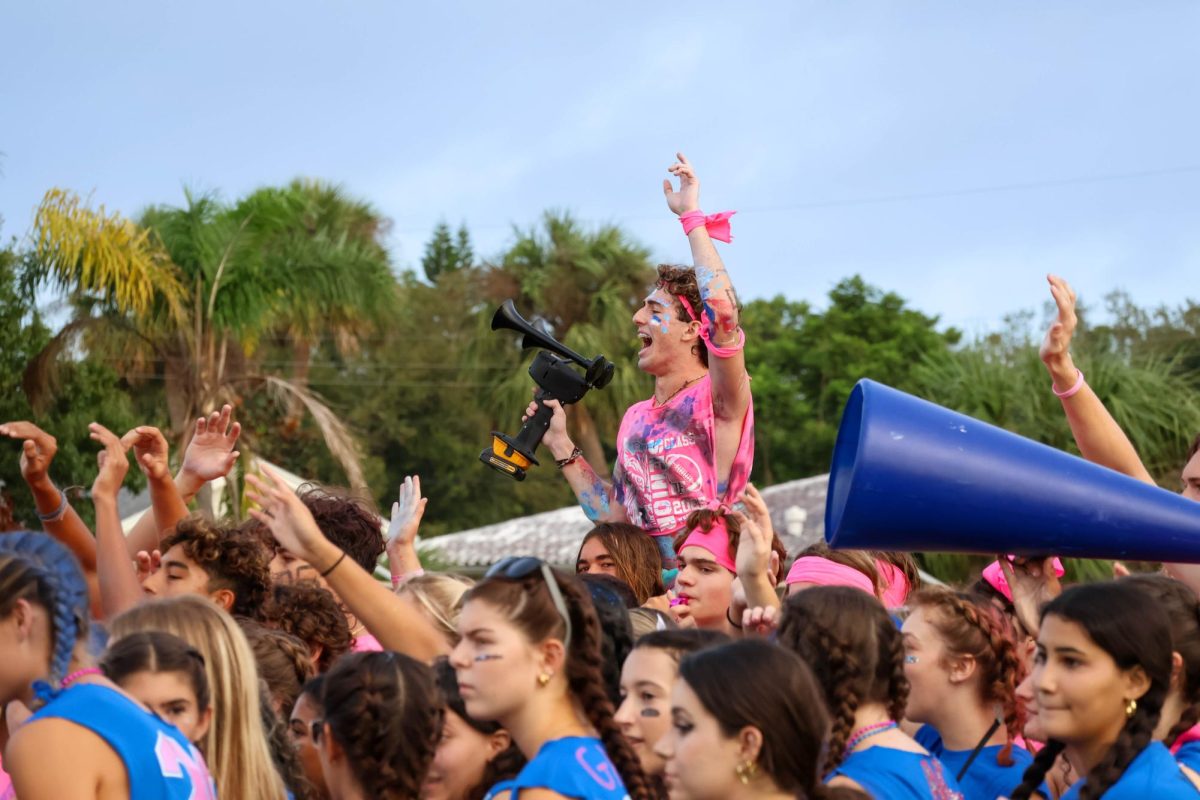 In the midst of a mob, senior Matthew Tucker rides atop the shoulders of senior Justin Tribou on Powderpuff day Sept. 27.