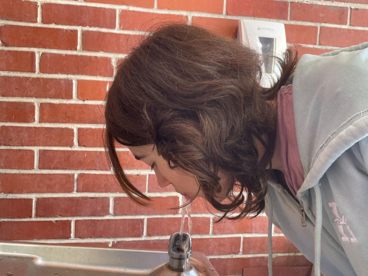 Freshman Talia Woods drinks from one of the school water fountains available on April 14 after the previous boil water notice was revoked, confirming Melbourne’s tap water supply to be safe for consumption.