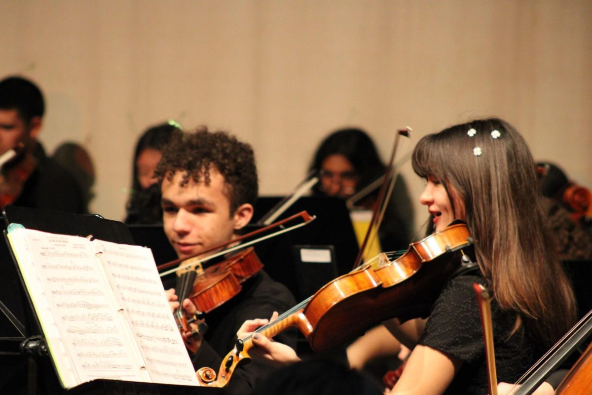 Sophomores David Amador (left) and Presley Haney play in the final orchestra performance of the year on April 22.