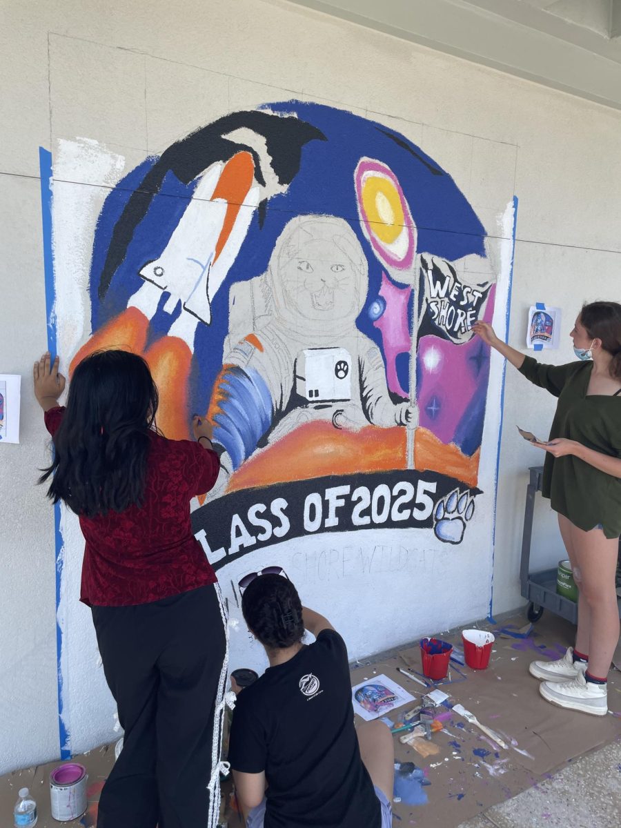 Students paint the space-themed “Class of 2025” mural on April 30.