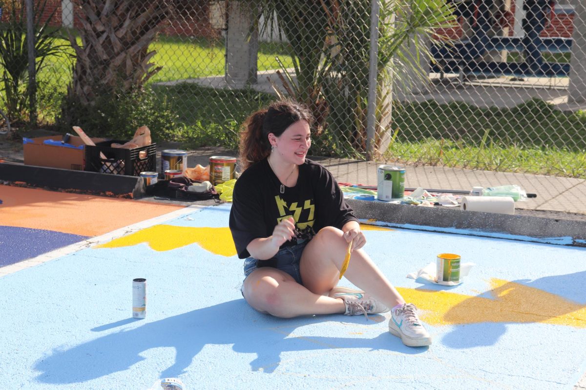 Senior Sarah McCray paints her parking spot on Sept. 7.