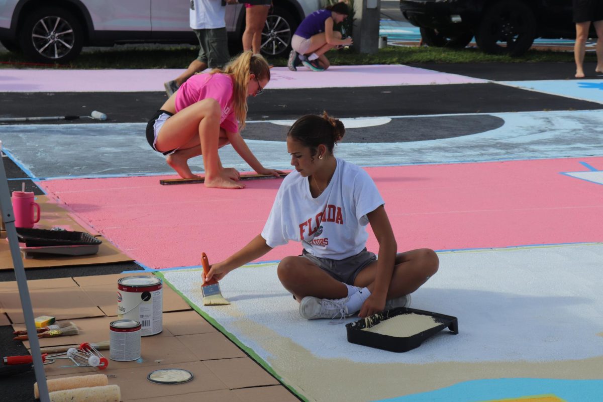 Senior Violet Castillo paints her parking spot on Sept. 7.