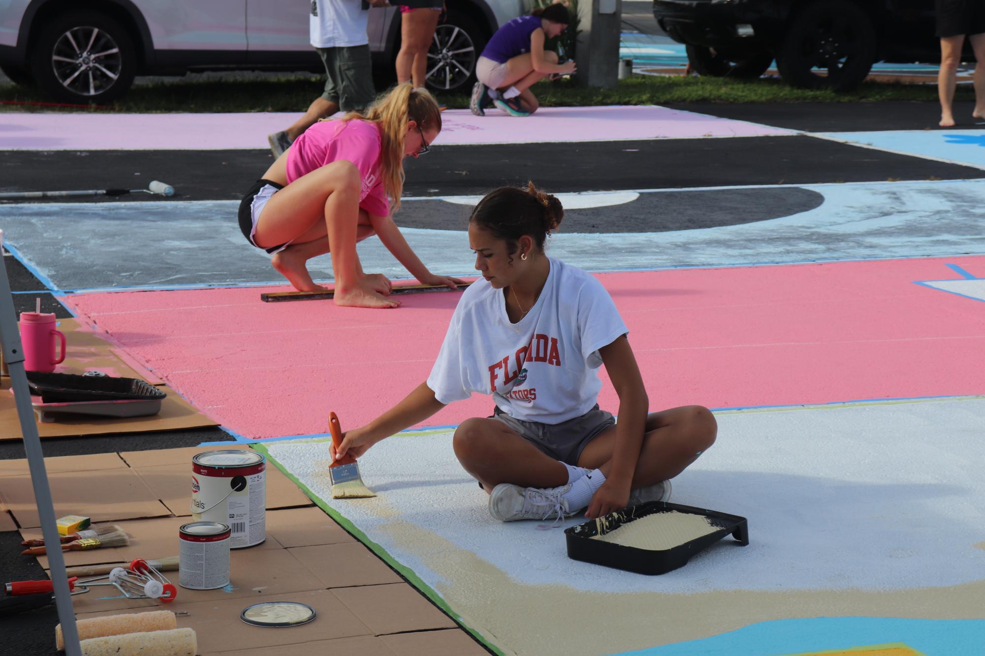 Senior Violet Castillo paints her parking spot on Sept. 7.