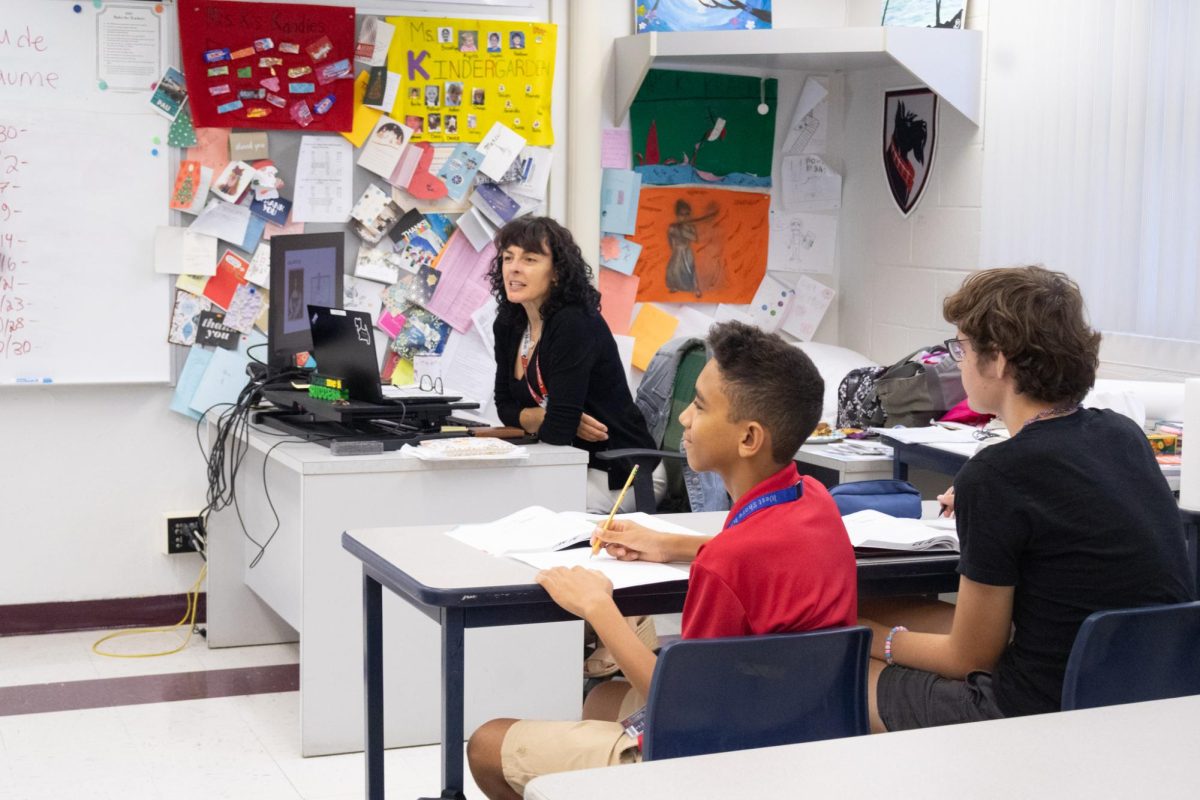 Sophomore Brevin Olson (right) and seventh grader Jason Delp listen to Russian teacher Elena Khlyabich present cultural information on Sept. 29.
