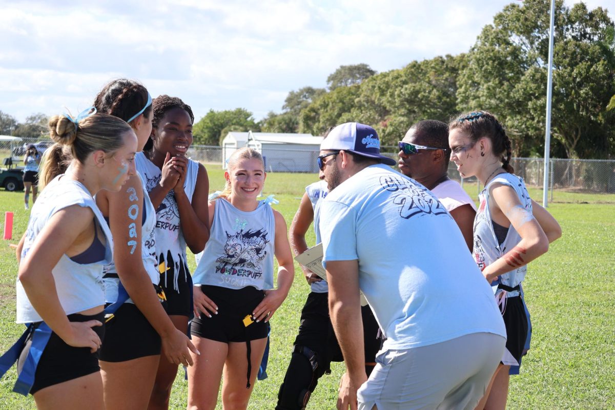 Junior Class Coach Corey Burton talks to the juniors before a play on Oct. 17. “I'm honestly really happy with how the game went," junior Jordyn Judge said. "It would have been better if we won, but I still had so much fun with my friends, and we all played really good. Next year we will have more practices and stuff, so I definitely think that we will win.”
