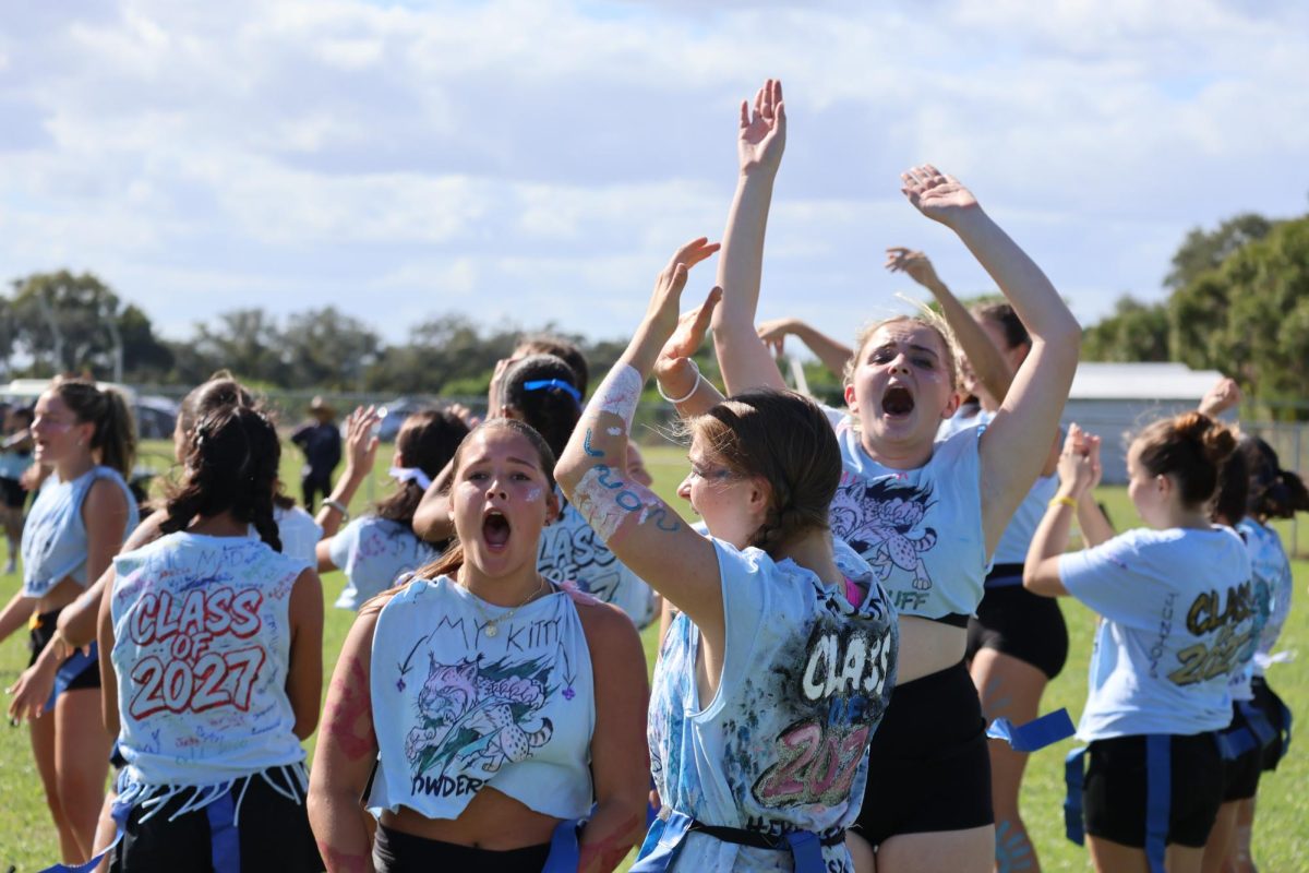 The junior girls cheer after scoring a touchdown. “It was a good game, the juniors won the first points," junior Maggie Qin said. "It’s powder-puff, so we all know there’s a little favor to the seniors. Next year, we’re definitely going to take it back.”