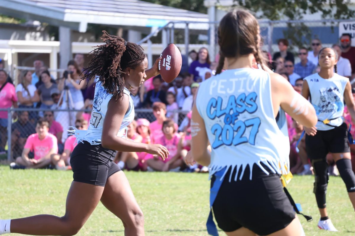 Junior Erynn Moffett runs with the football on Oct. 17. “I was a little sad we didn’t win," Moffett said. "When I scored the touchdown, I was just happy we scored.”