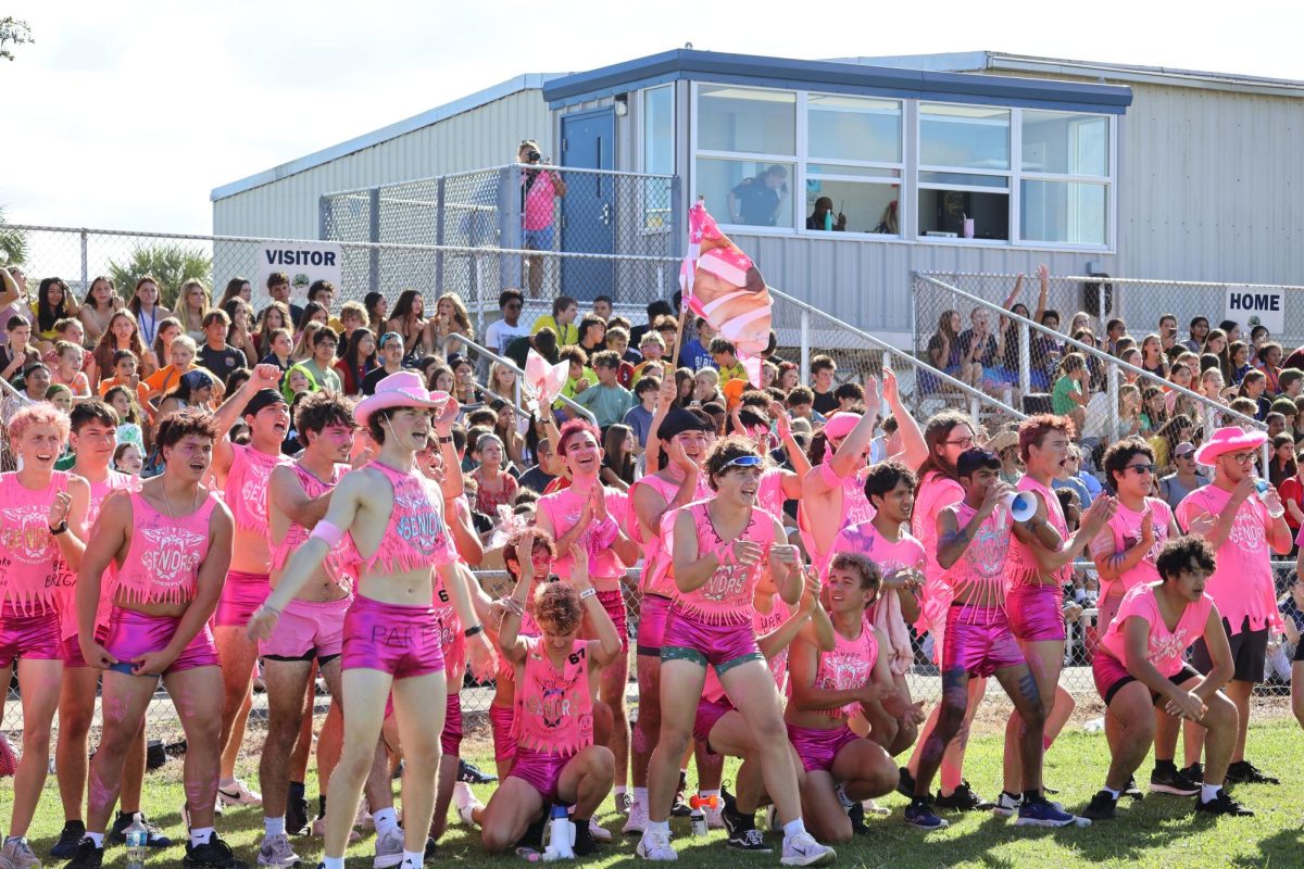 The senior boys cheer on the senior girls on Oct. 17. “The seniors’ spirit was completely unmatched, and we had so much more energy than the juniors all day," senior Jude Richardson said. "After the hot, hunky cheerleaders gave the performance of a lifetime, we knew that the girls were gonna lock in and get that W.”