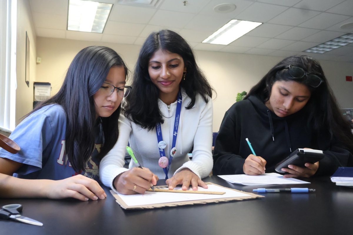 Seniors Thien-Linh Nguyen (left), Meghana Geddam (center) and Ziva Lopez (right) complete written
assignment on Kepler’s three laws of heliocentrism on Sept. 19.