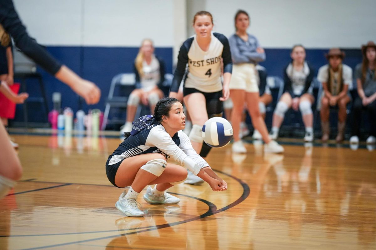 Senior libero Alice Lin crouches to receive a serve during a 3-0 win against
Eau Gallie on Aug. 21. “Playing libero means doing the dirty work so others
can have their moments to shine,” Lin said. “I feel so honored to be entrusted
with the jersey, and although it comes with great responsibility, I embrace
the challenge.” She led the team in two statistical categories with five digs
and 10 serve receptions. Lin said that facing Eau Gallie in the second game
of the season gave the team a glimpse of their true potential.