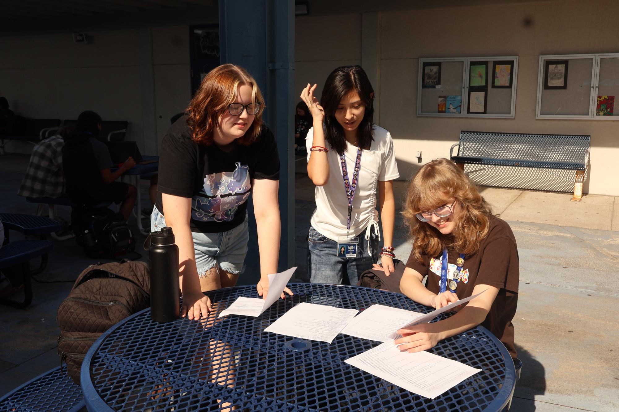 Reading over stage directions for,
“Beetlejuice Jr,” sophomores assistant
stage manager Elizabeth Gibson (left),
props and costumes manager Cathryn
Cooper (center) and light manager Riley
Henderson (right) finalize the lighting and
sound cues for the production on Nov.
13, a day before opening night. “It’s my job
to take things on set and take things off,”
Gibson said. “I make sure the backstage cues are all organized."