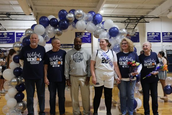 With her family and Coach Derek Hamilton (third from left) by her side, senior Emily Marshall (fourth from left) celebrates as she walks down the basketball court before the girls basketball Senior Night game versus Odyssey Charter School on Jan. 28. "My senior night being my last regular season game felt so crazy," Marshall said. "Senior Night really made all the sacrifices and hardships I went through to keep playing basketball feel worth it, and I'm grateful for my team making it so special."