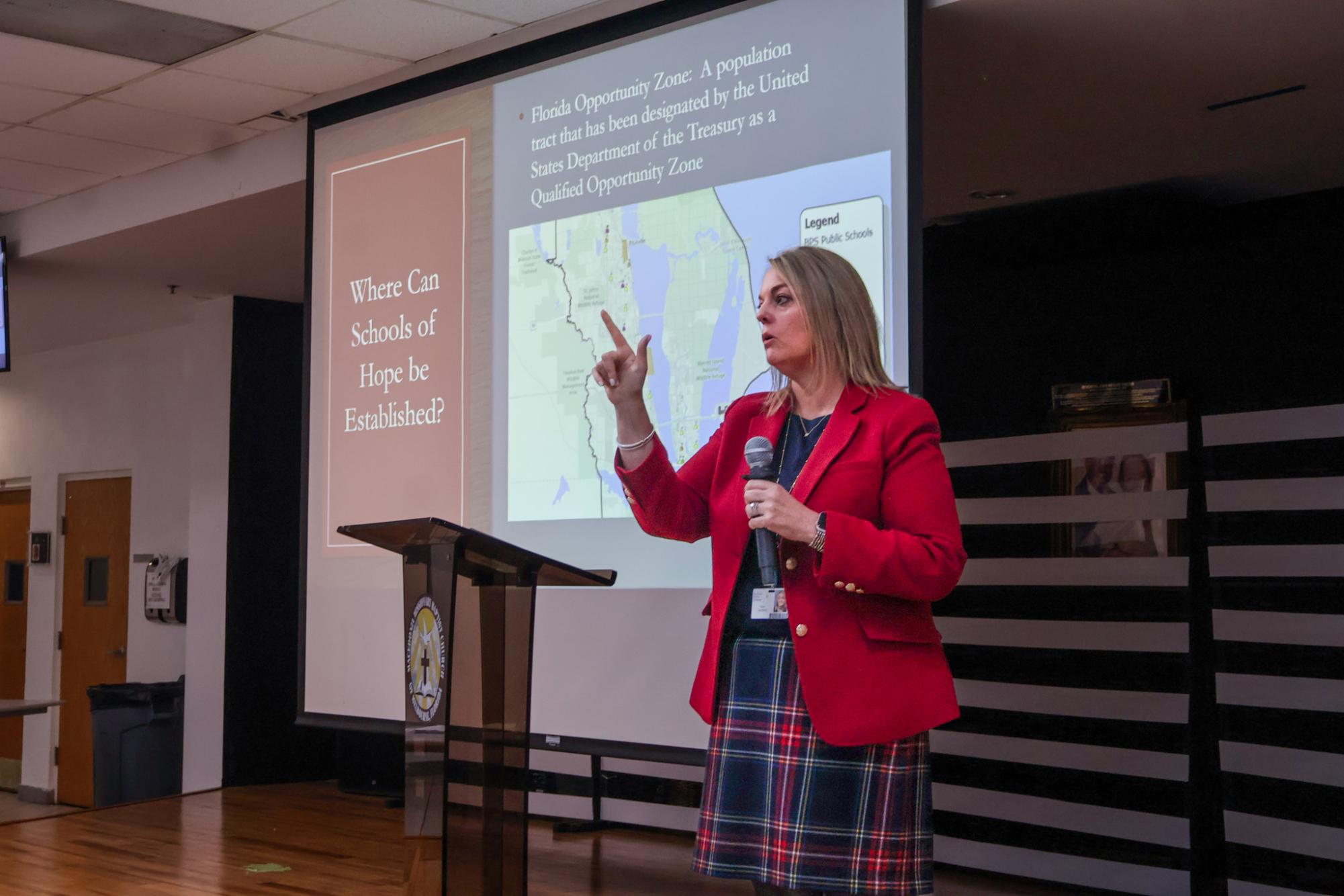 Explaining the implications of the Schools of Hope legislation at a South Brevard advocate meeting, Assistant 
Superintendent Tara Harris showcases the map of Florida Opportunity Zones, where co-location may occur.