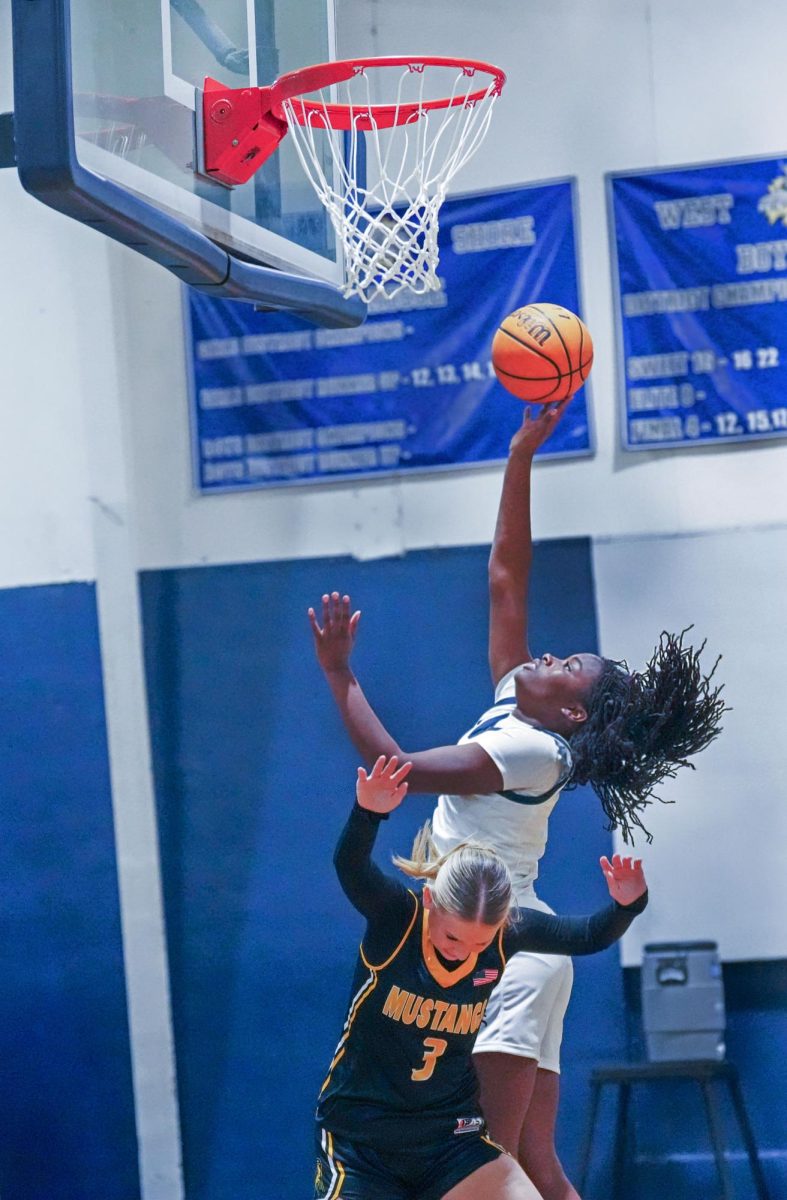 Rising above her opponent, junior Erynn Moffett attemps a layup in a blowout
56-19 win over Merritt Island on Nov. 19. “The season is going pretty good for us
and the team,” Moffett said. “We are doing better than everyone expected, and I
hope that we can go far in the playoffs this season.” Moffett finished the regular
season leading the team in points (397), assists (70), rebounds (149) and steals
(104).