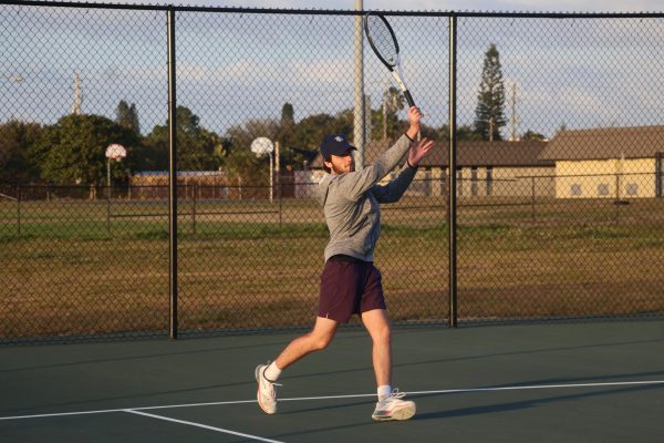 Practicing at the Hoover tennis courts on Jan. 20, senior Giorgio Rotolo works on his forehand before his next match.