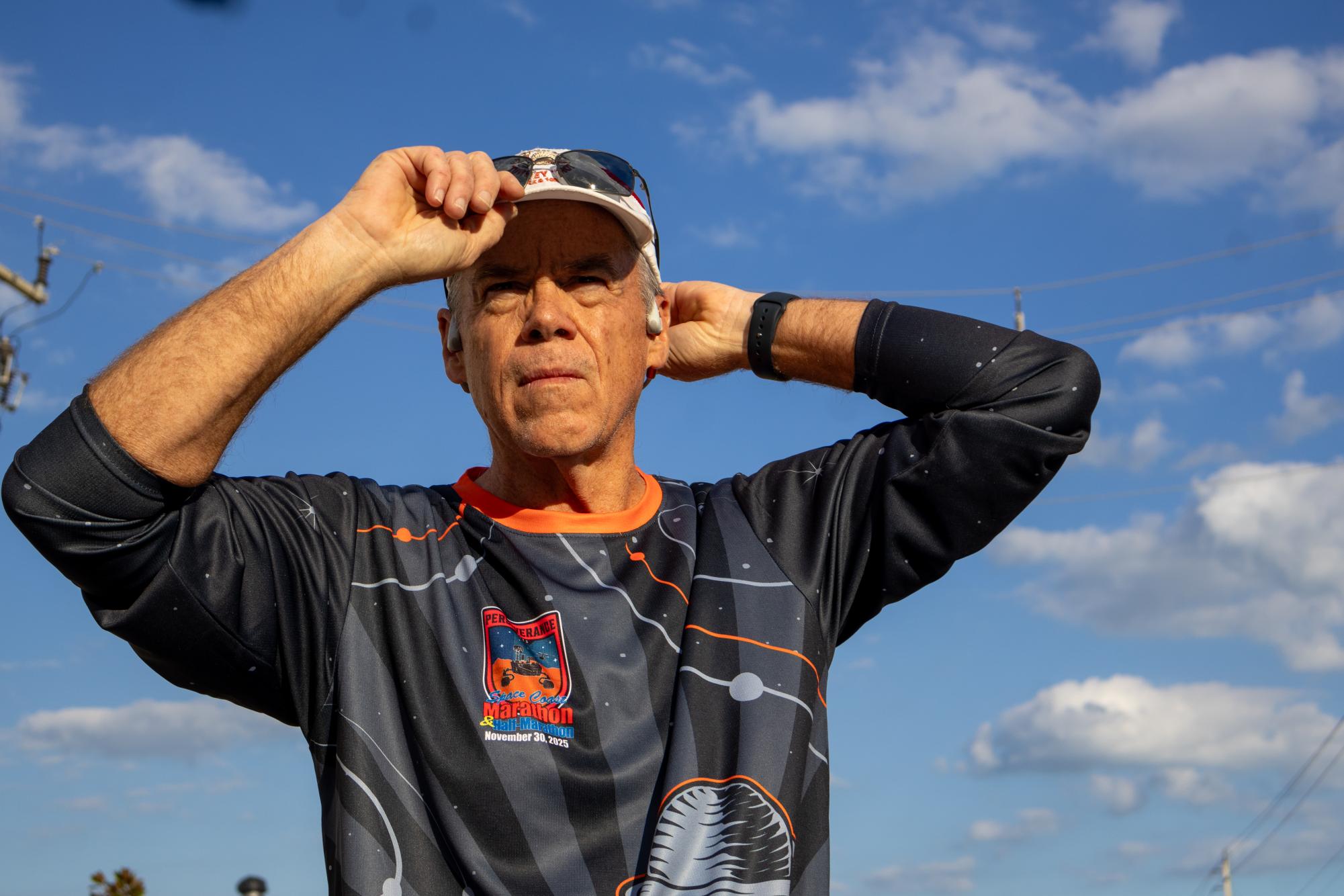 Tightening his running hat, Assistant Principal Glenn Webb prepares for a 20-mile long run after a 12-hour work day on Wildcat Alley on Feb. 4. Webb progressed through his training plan to prepare him for the Heath First Florida Marathon Weekend  Half Marathon on Feb. 8, and a full marathon in the near future.