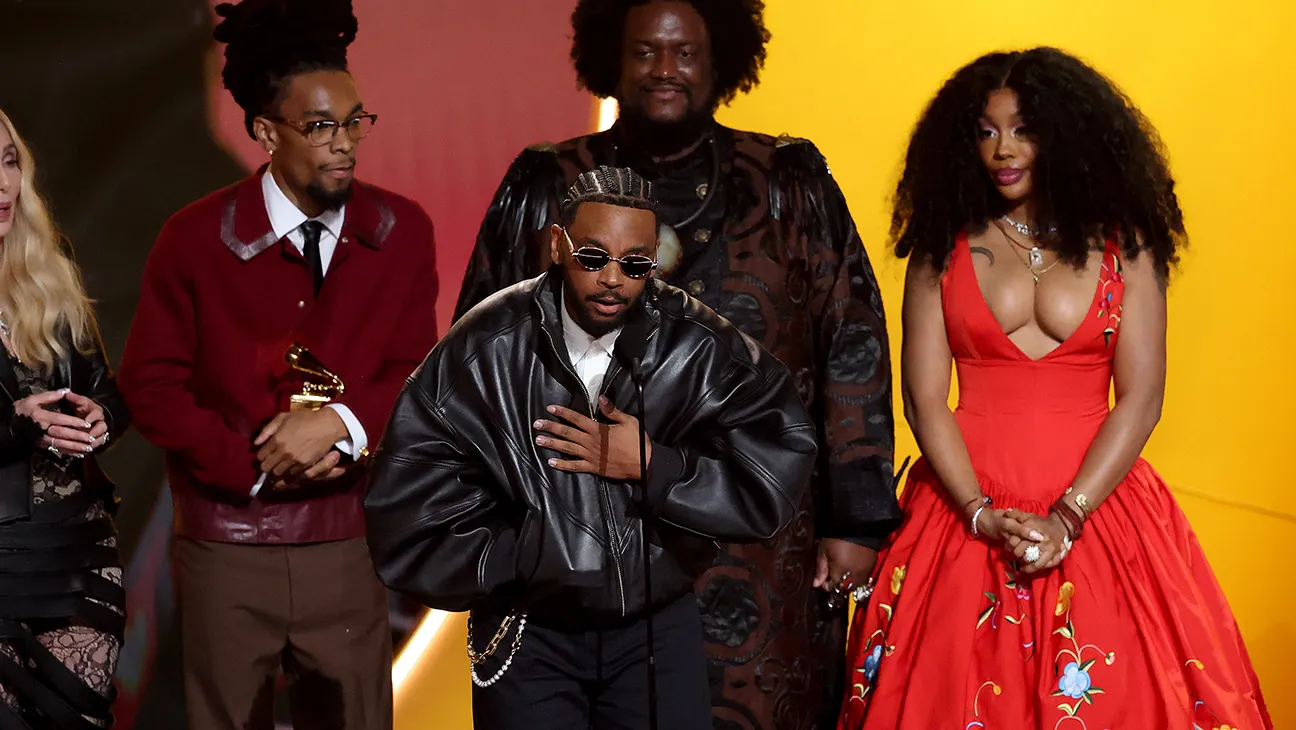 In a homage to classic R&B, Kendrick Lamar (front center) and SZA (right) accept their award for Record of the Year at the 68th annual Grammy Awards.
