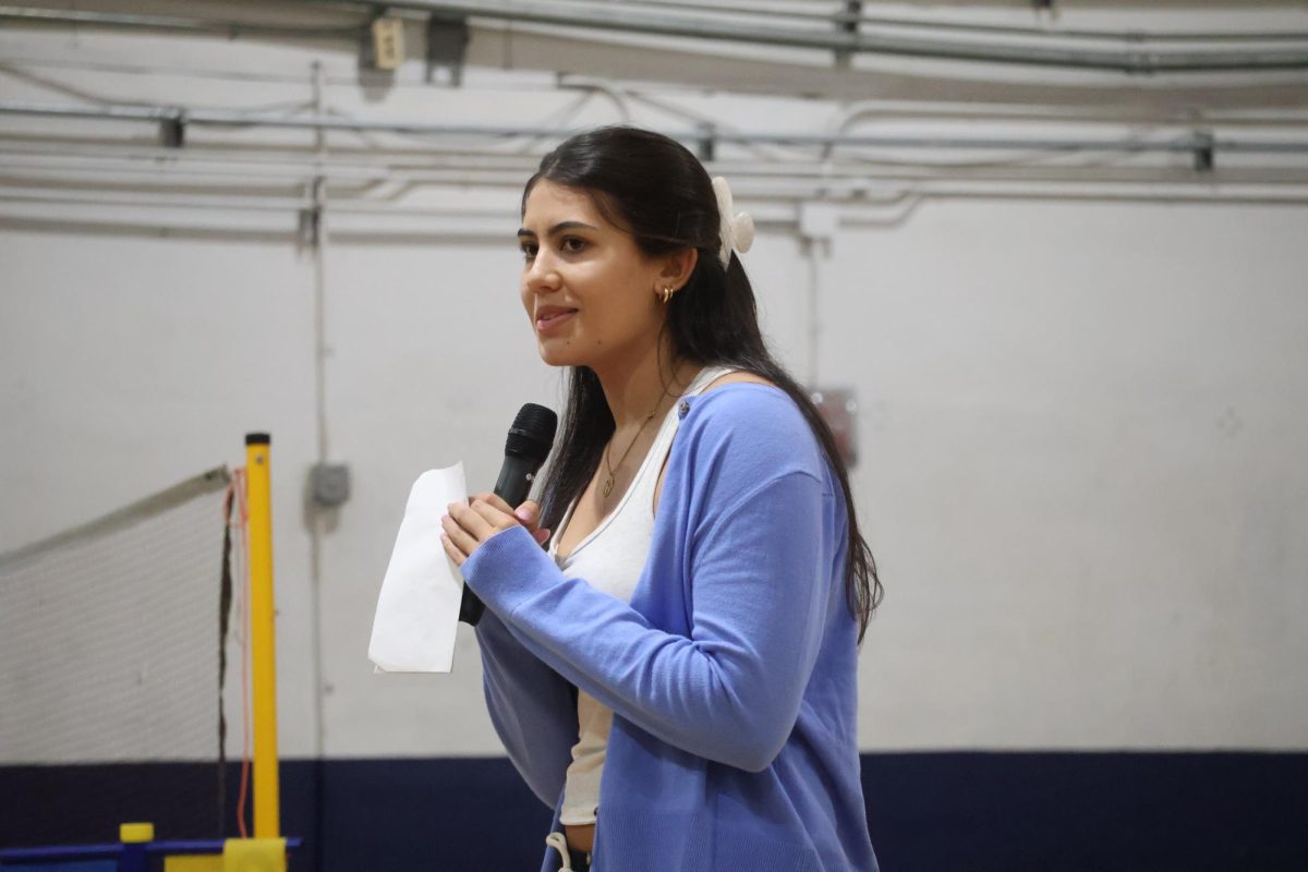 Giving her campaign speech in the gym on Wednesday, April 22, senior class treasurer candidate Anita Mahindra talks about her plans for next year.  