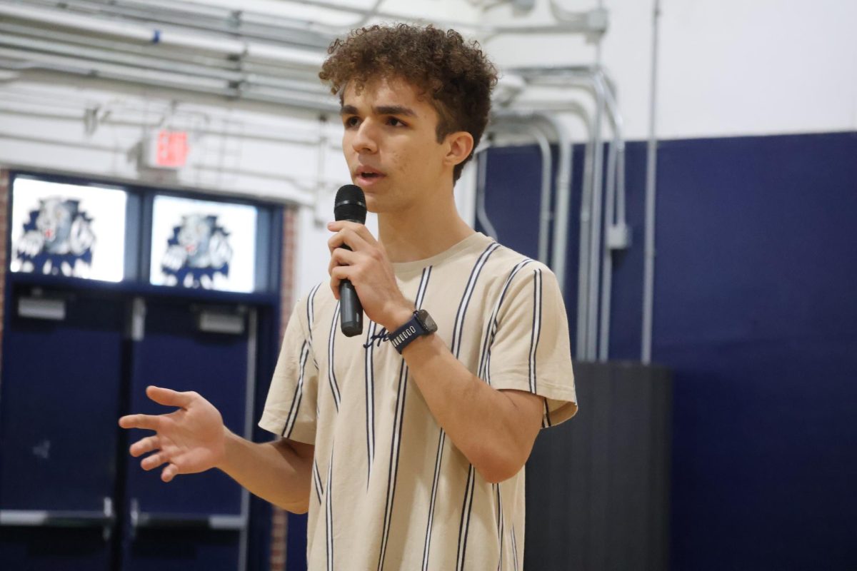 Sharing his experiences as the junior class treasurer, senior class treasurer candidate David Amador gives his speech in the gym on Wednesday, April 22. 