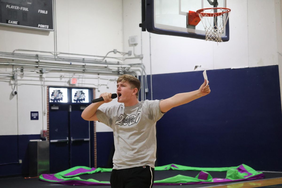 Hyping up the audience for his speech, senior class vice president candidate Daniel Mirell begins his speech in the gym on Wednesday,  April 22. 