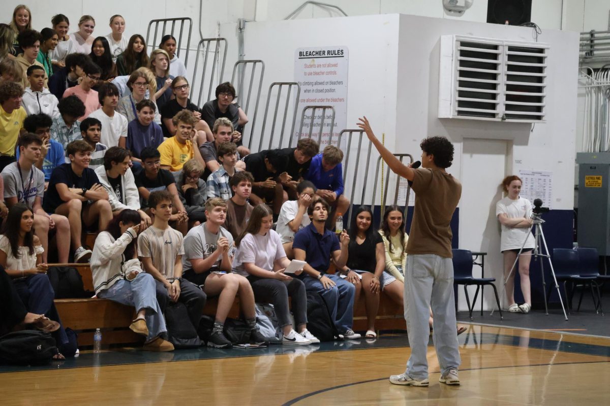 Silencing the crowd, senior class presidential candidate Matthew Grainger begins his campaign speech in the gym on Wednesday, April 22. 