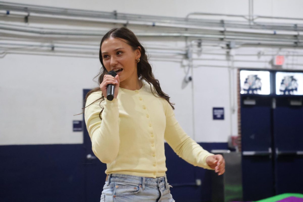 Being the first candidate to speak, senior class historian candidate Eleanor Alderman begins her speech in the gym on Wednesday, April 22.