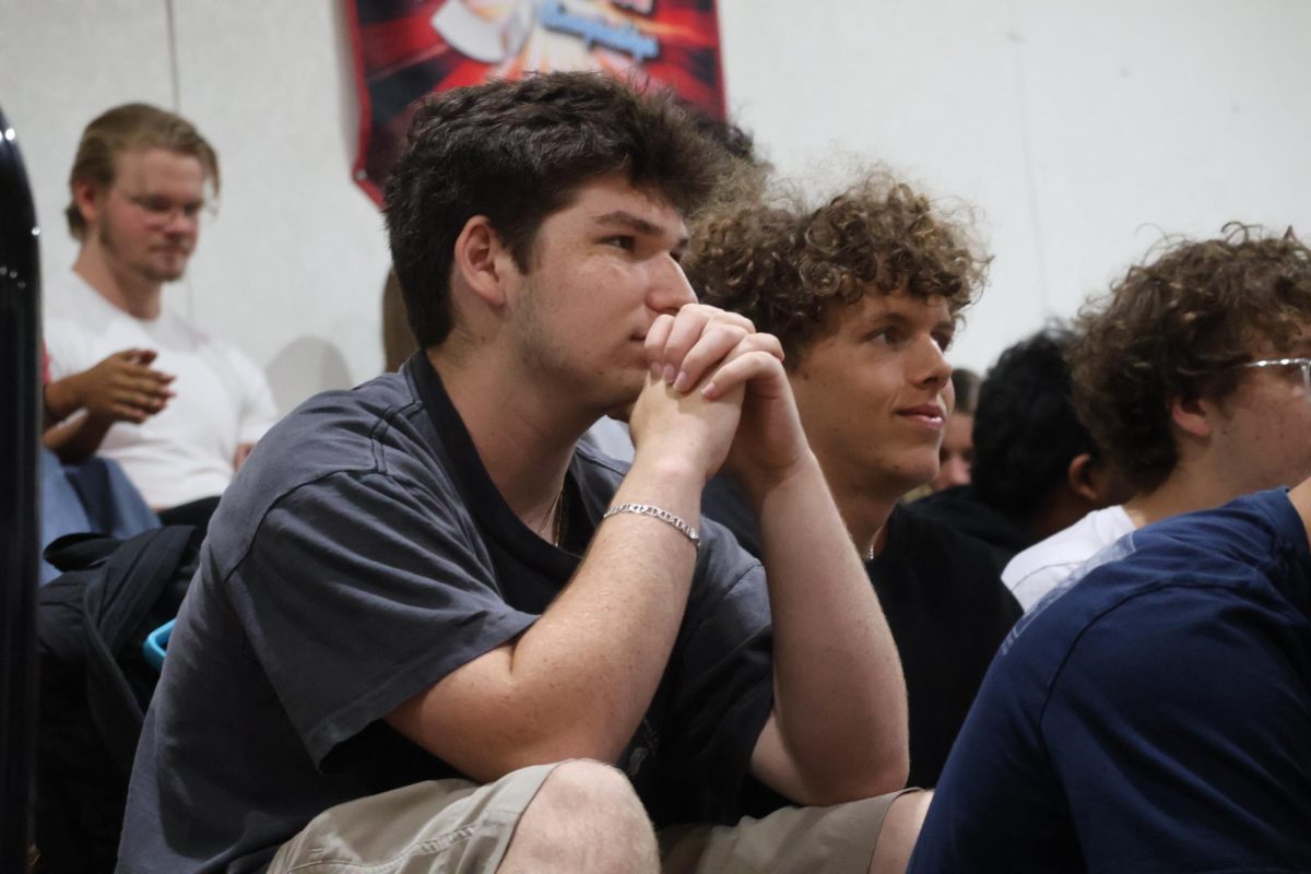 Listening to the senior class candidates give their campaign speechs in the gym on Wednesday, April 22, junior JAj Price pays attention to the current speaker. 